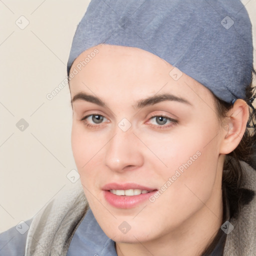 Joyful white young-adult female with short  black hair and brown eyes