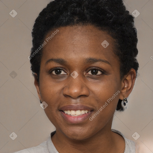 Joyful black young-adult female with short  black hair and brown eyes