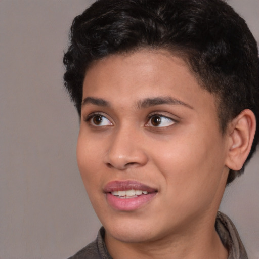 Joyful black young-adult female with short  brown hair and brown eyes