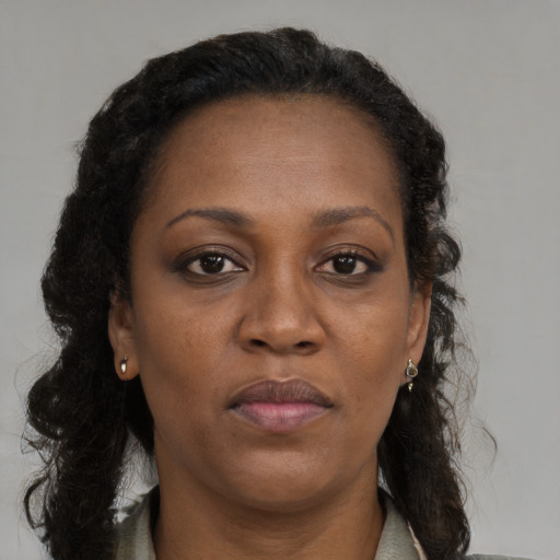 Neutral black adult female with long  brown hair and brown eyes