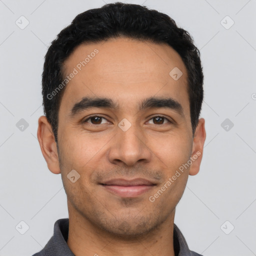 Joyful latino young-adult male with short  black hair and brown eyes