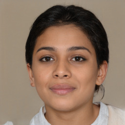 Joyful latino young-adult female with short  brown hair and brown eyes