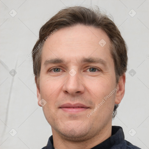 Joyful white adult male with short  brown hair and grey eyes