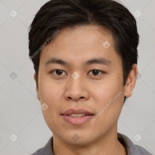 Joyful asian young-adult male with short  brown hair and brown eyes