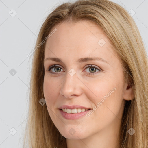 Joyful white young-adult female with long  brown hair and brown eyes