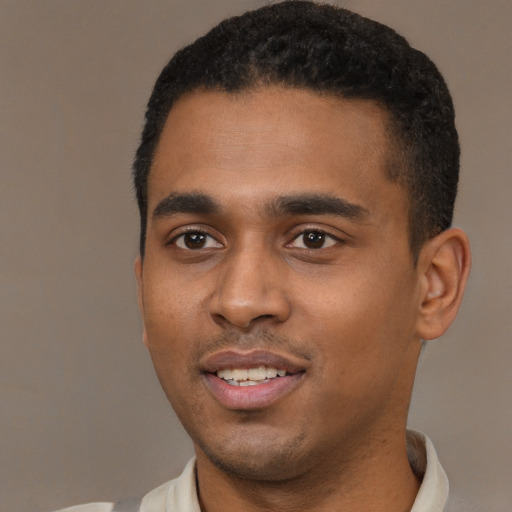 Joyful black young-adult male with short  black hair and brown eyes
