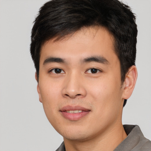 Joyful white young-adult male with short  black hair and brown eyes