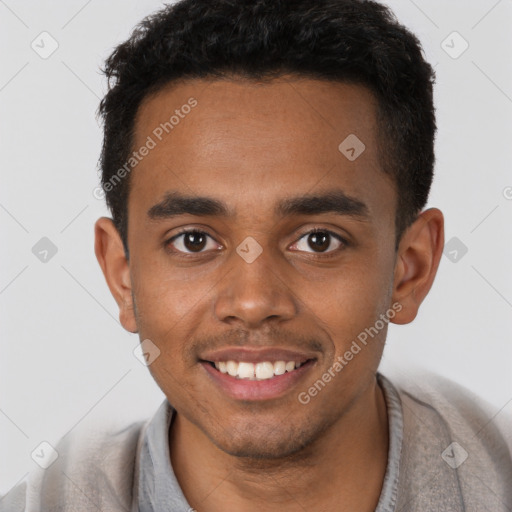 Joyful black young-adult male with short  brown hair and brown eyes