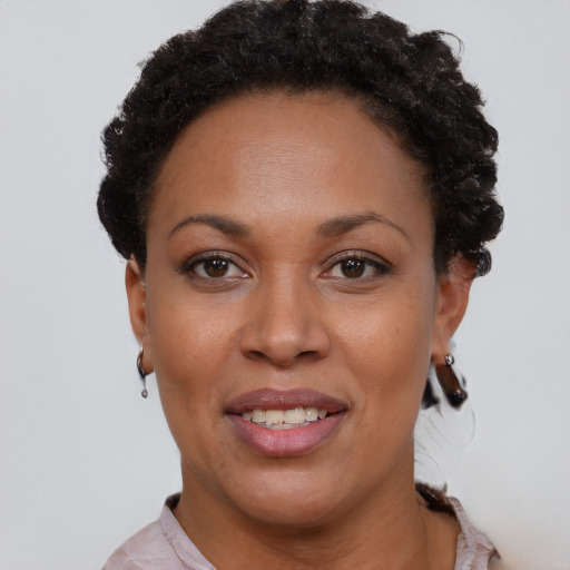 Joyful black young-adult female with short  brown hair and brown eyes