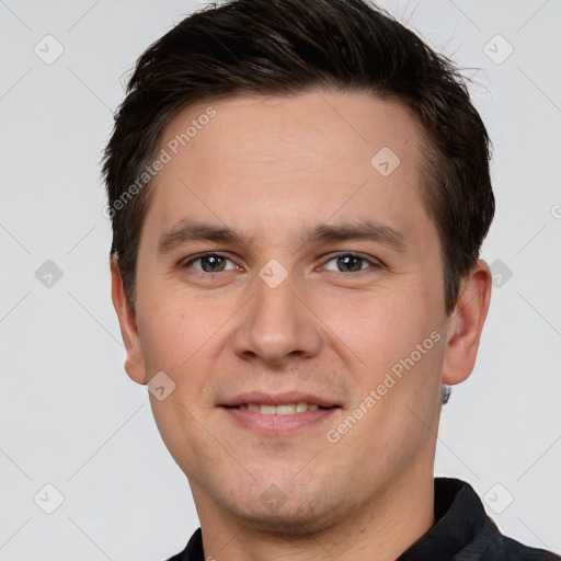 Joyful white young-adult male with short  brown hair and brown eyes