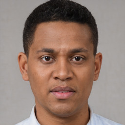 Joyful latino young-adult male with short  brown hair and brown eyes