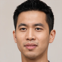 Joyful asian young-adult male with short  black hair and brown eyes