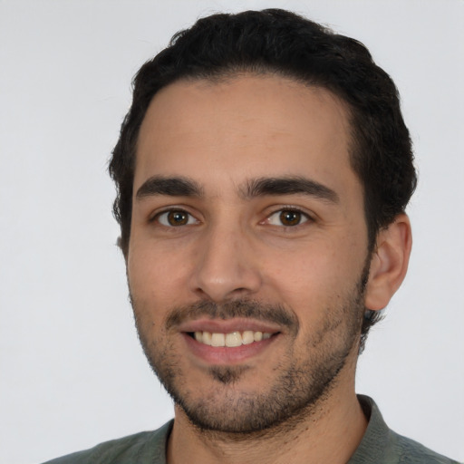 Joyful white young-adult male with short  black hair and brown eyes