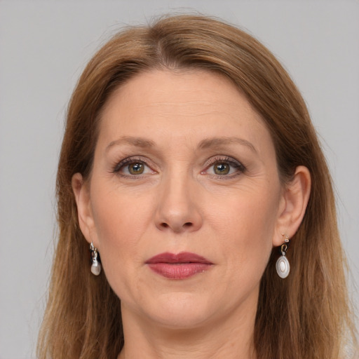 Joyful white adult female with long  brown hair and grey eyes