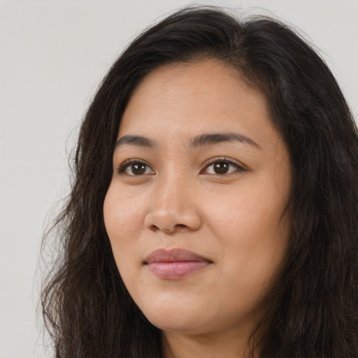 Joyful asian young-adult female with long  brown hair and brown eyes