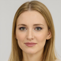 Joyful white young-adult female with long  brown hair and green eyes