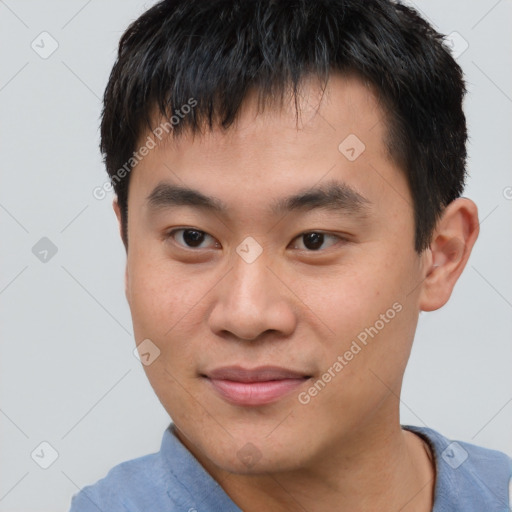 Joyful asian young-adult male with short  brown hair and brown eyes