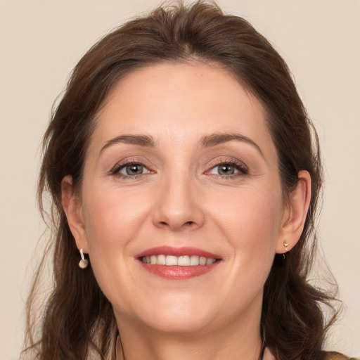 Joyful white young-adult female with long  brown hair and grey eyes