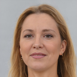 Joyful white adult female with long  brown hair and brown eyes