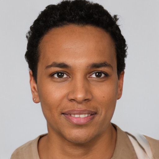 Joyful black young-adult male with short  black hair and brown eyes