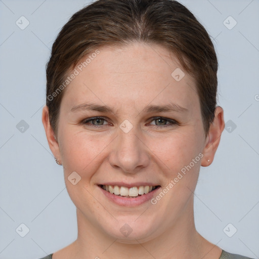 Joyful white young-adult female with short  brown hair and grey eyes