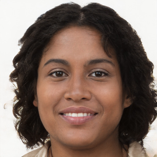 Joyful black young-adult female with long  brown hair and brown eyes