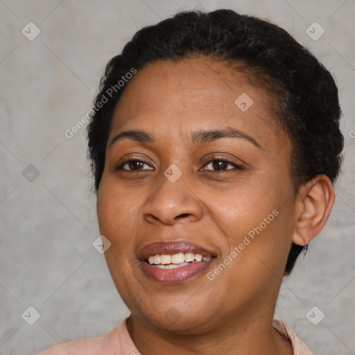 Joyful black adult female with short  brown hair and brown eyes