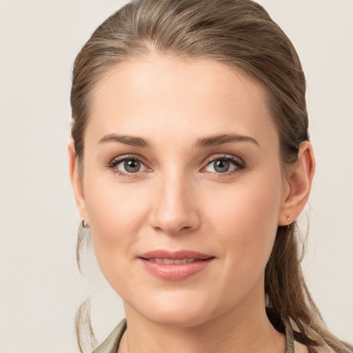 Joyful white young-adult female with medium  brown hair and grey eyes