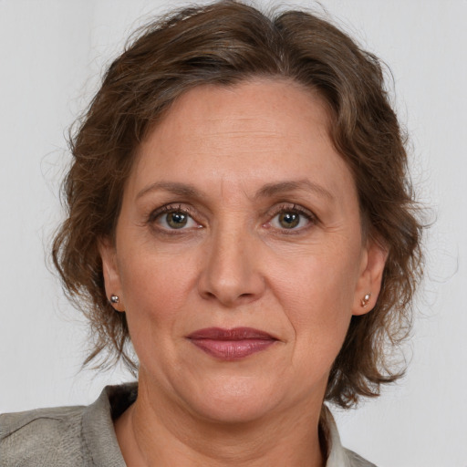 Joyful white adult female with medium  brown hair and grey eyes