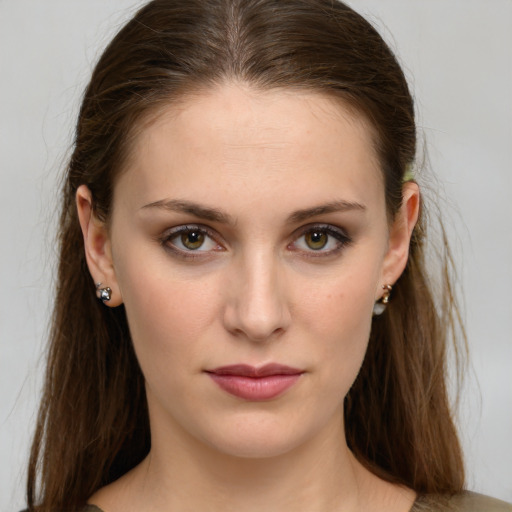 Joyful white young-adult female with medium  brown hair and green eyes