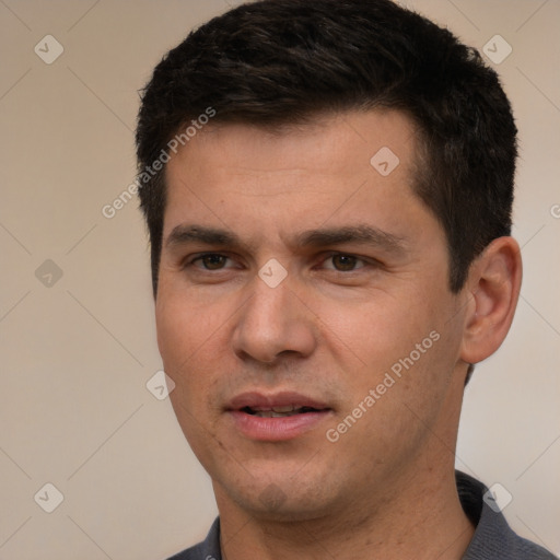 Joyful white young-adult male with short  black hair and brown eyes