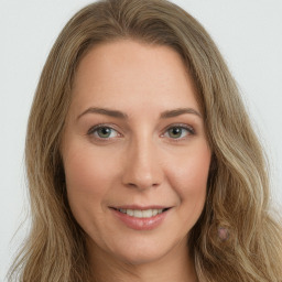 Joyful white young-adult female with long  brown hair and green eyes