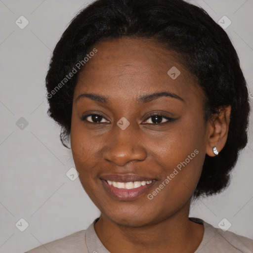 Joyful black young-adult female with short  black hair and brown eyes