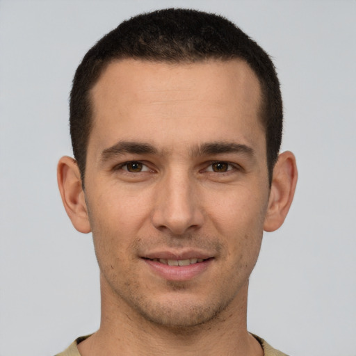 Joyful white young-adult male with short  brown hair and brown eyes