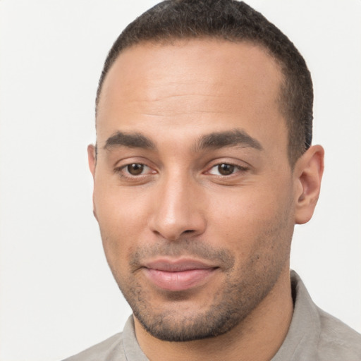 Joyful black young-adult male with short  brown hair and brown eyes