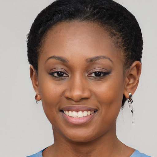 Joyful black young-adult female with short  brown hair and brown eyes