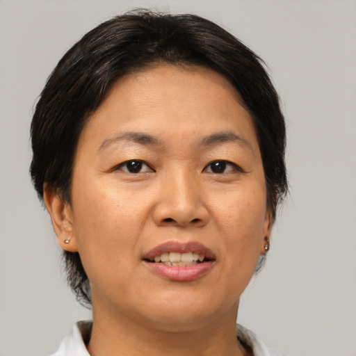 Joyful asian adult female with medium  brown hair and brown eyes