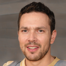 Joyful white adult male with short  brown hair and brown eyes