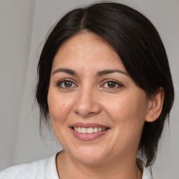 Joyful white adult female with medium  brown hair and brown eyes