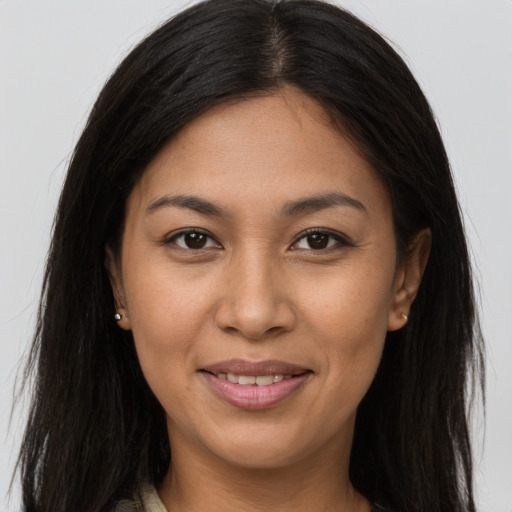 Joyful asian young-adult female with long  brown hair and brown eyes