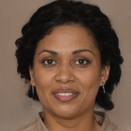 Joyful black adult female with medium  brown hair and brown eyes