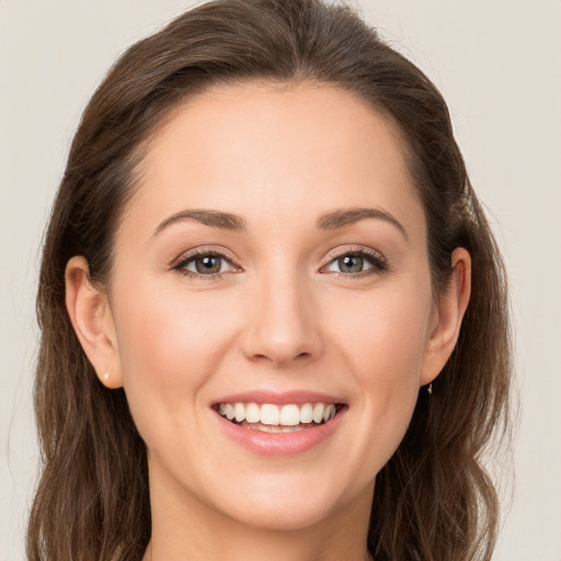 Joyful white young-adult female with long  brown hair and brown eyes