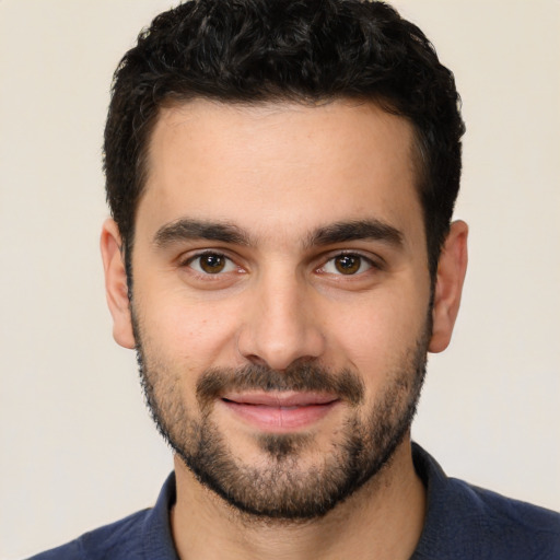 Joyful white young-adult male with short  black hair and brown eyes