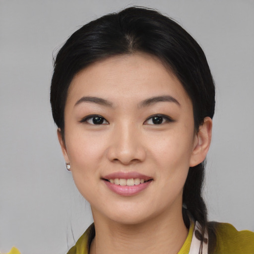 Joyful asian young-adult female with medium  black hair and brown eyes