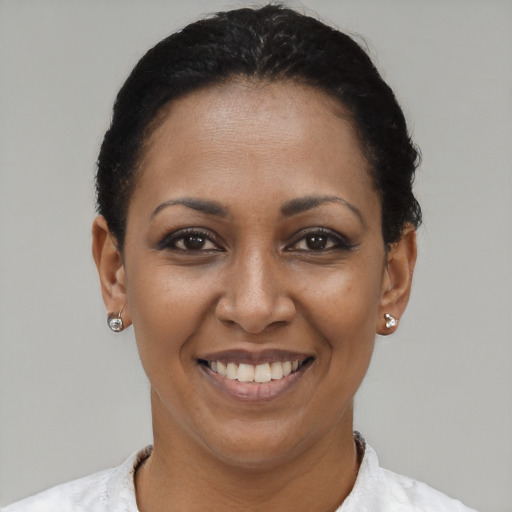 Joyful latino young-adult female with short  brown hair and brown eyes