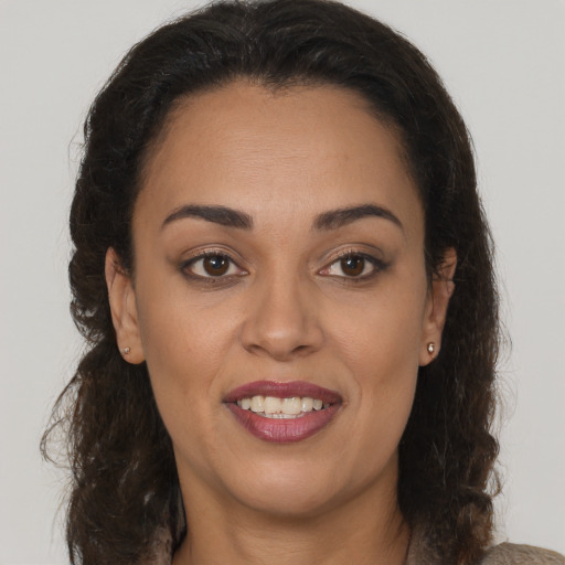 Joyful latino young-adult female with medium  brown hair and brown eyes