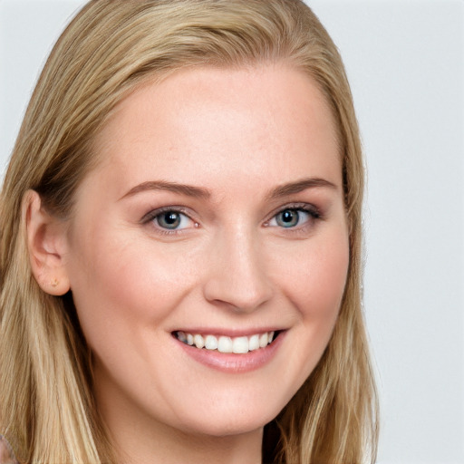 Joyful white young-adult female with long  brown hair and blue eyes