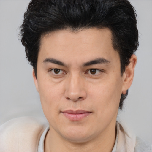Joyful latino young-adult male with short  brown hair and brown eyes