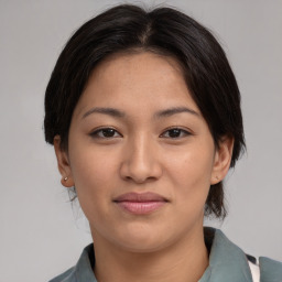 Joyful asian young-adult female with medium  brown hair and brown eyes