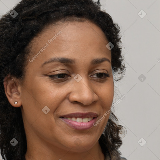 Joyful black young-adult female with long  brown hair and brown eyes